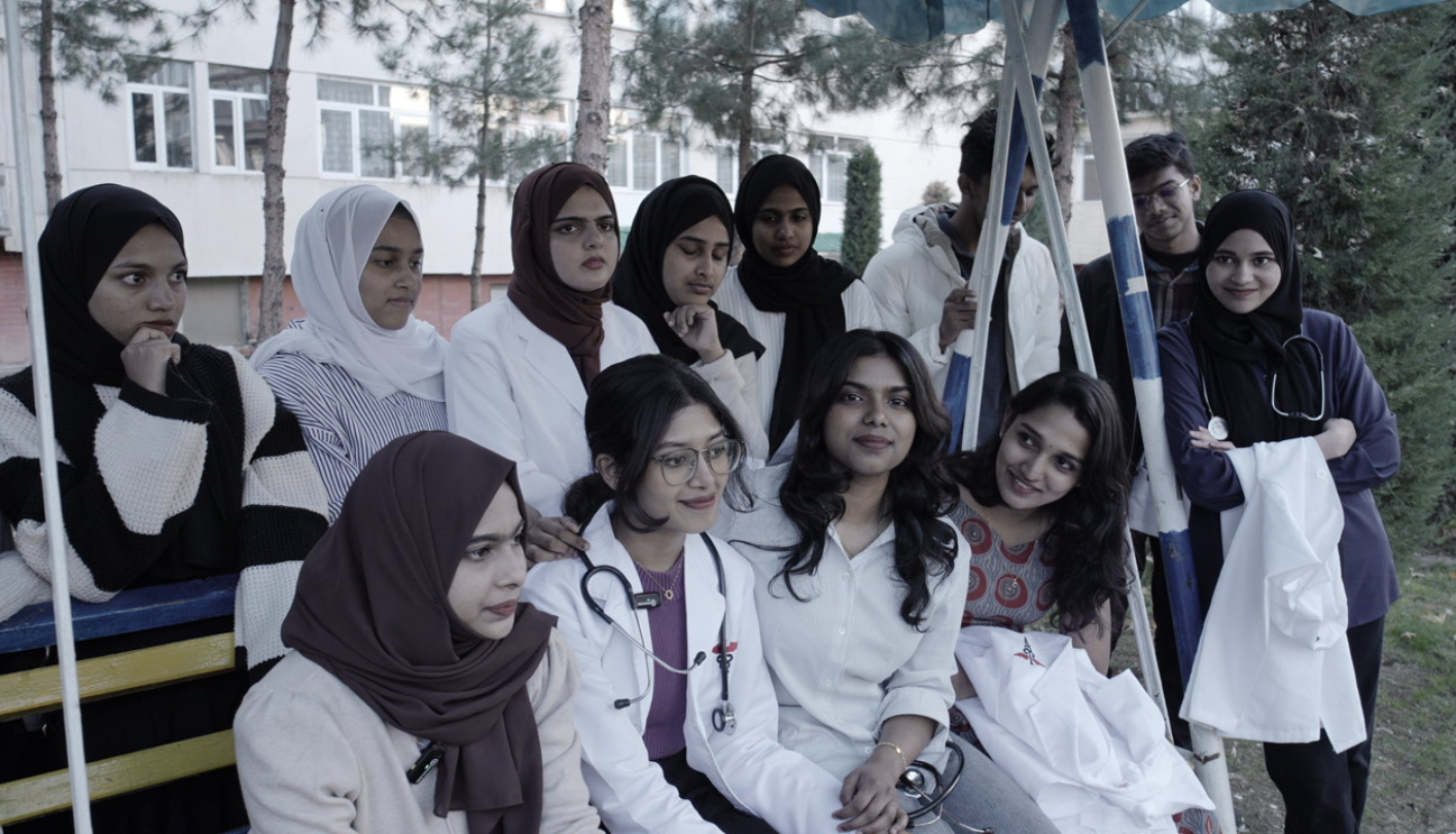 Group of students in white coats outside their medical university